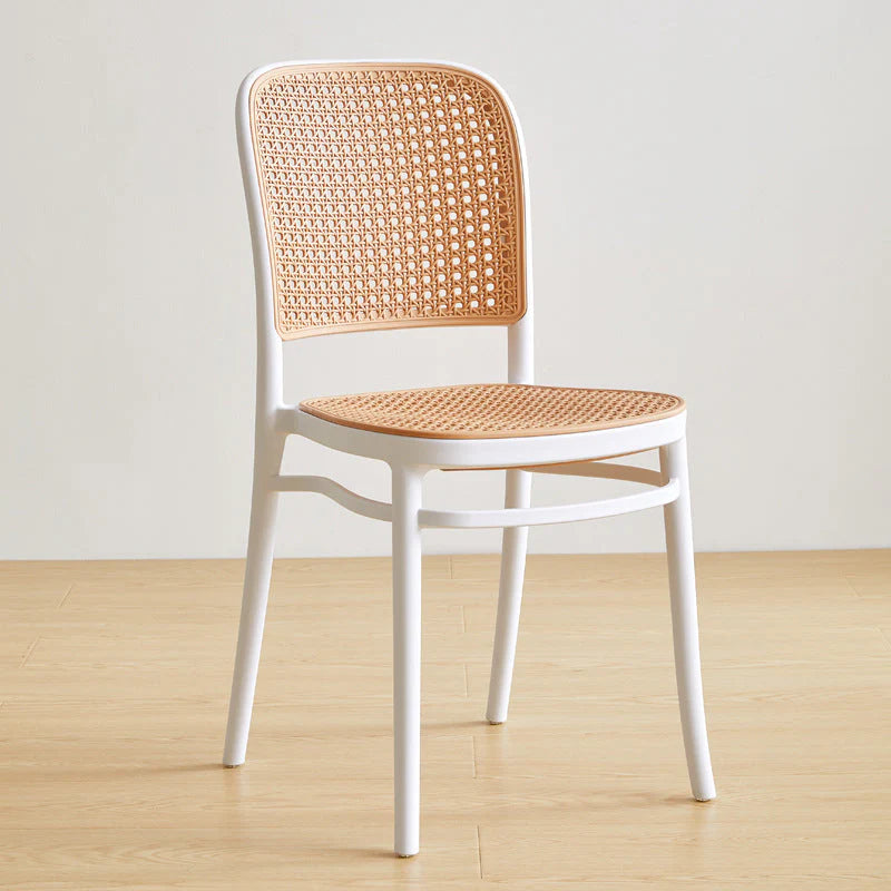 Dining Chairs with woven backrest and seat on a wooden floor